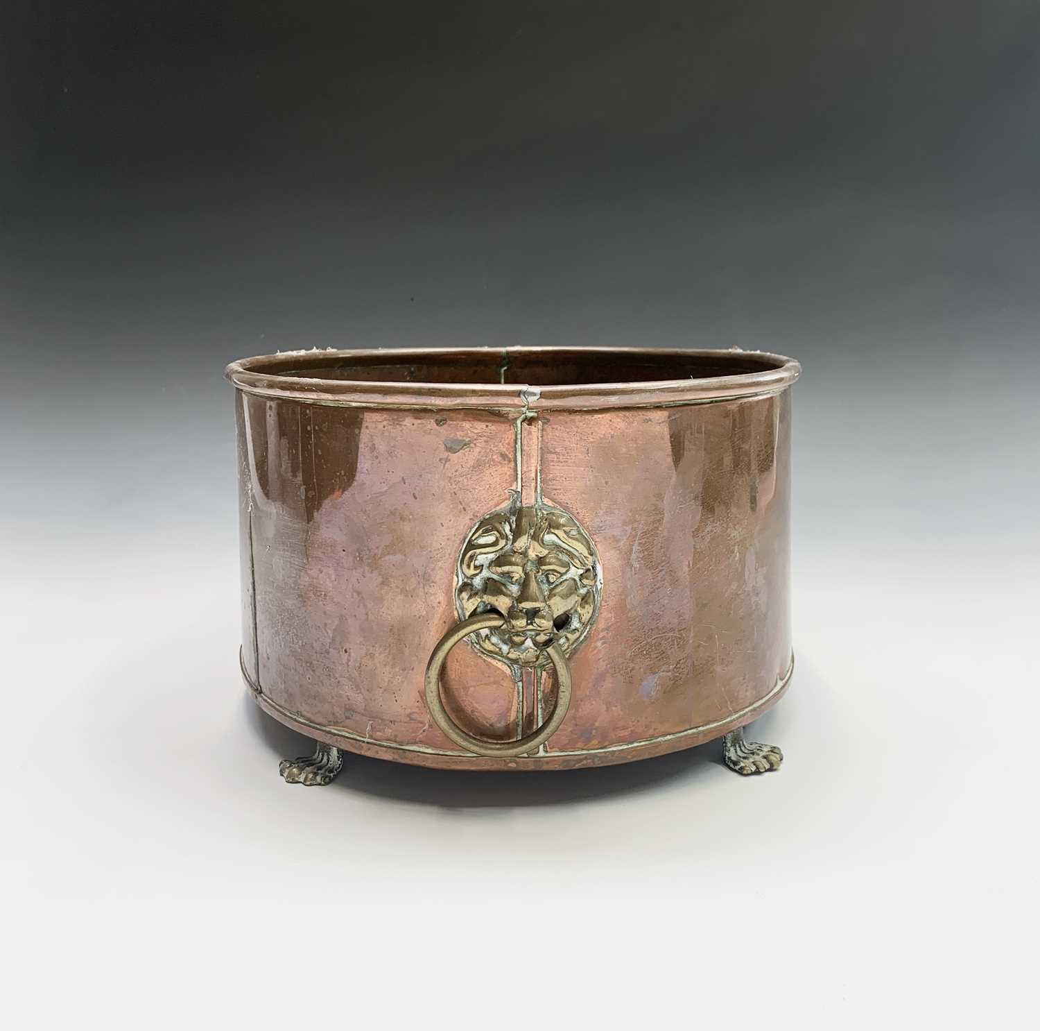 A copper plant trough of oval form, with brass lion's mask handles and paw feet. Height 15.5cm, - Image 2 of 2