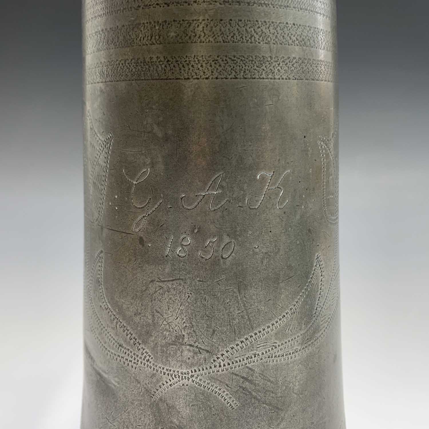 A 19th century pewter flagon with hinged cover, engraved with tulips and initialled G.A.K. and dated - Image 5 of 20