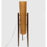 A 1970s teak "rocket" floor standing lamp, with fibreglass cylindrical shade on three feet, height
