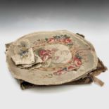 An 18th century needlework panel, possibly a cover for a stool or box, an oval panel - two deer