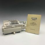 An Olympia Brunviga 13RM calculating machine, length 30cm with the instruction book.