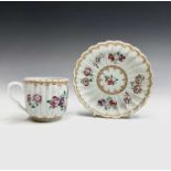 A Samson porcelain armorial cup and saucer, with fluted decoration and painted in the famille rose