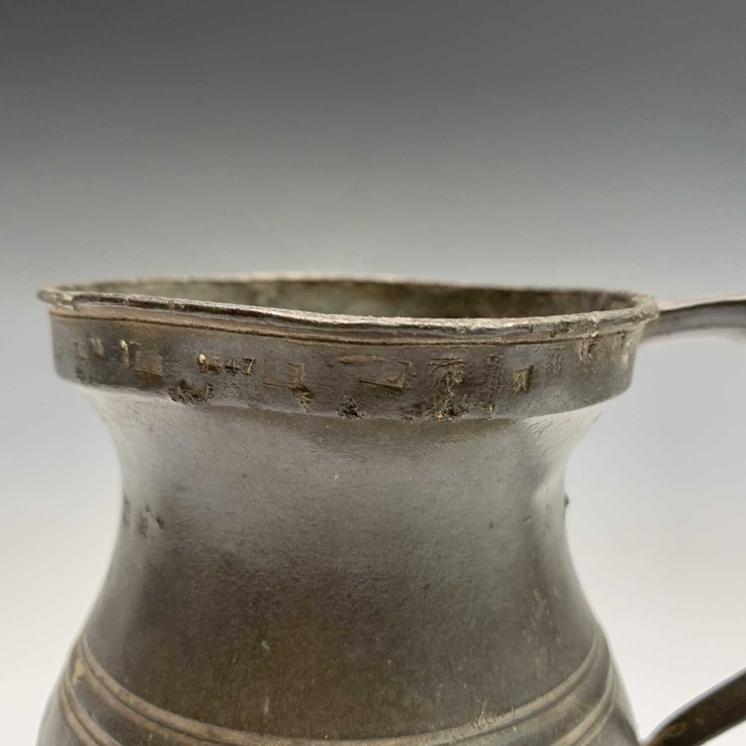 A 19th century pewter flagon with hinged cover, engraved with tulips and initialled G.A.K. and dated - Image 13 of 20