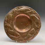 A Newlyn copper charger, the border repousse decorated with fish, inscribed verso 'The Newlyn