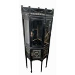 A Victorian aesthetic movement ebonised corner cabinet, with glazed door, the lower part with