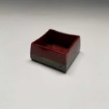 A Bernard Moore art pottery small pot, of slightly tapered square section, the red ground with