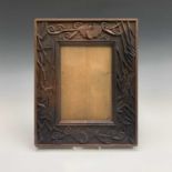 A pair of Aesthetic movement oak picture or mirror frames, carved with two bats and birds in