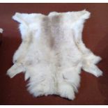 A reindeer fur rug. 122cm x 102cm.