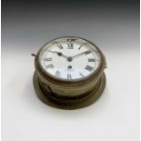 A brass ship's bulkhead clock, by Smith's, Cricklewood, with white enamel dial, diameter 23.5cm.