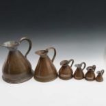 A group of six Victorian copper measuring jugs of various sizes, the largest height 28cm.