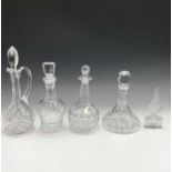 Three decanters, a claret jug, height 35cm, and a scent bottle (5).