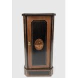 A Victorian mahogany and ebonised bedside cabinet, the door with an oval inlaid panel filled with