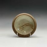 Leach pottery, A small dish, the celadon ground with incised decoration, diameter 11cm.