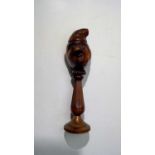 A 19th century fruitwood nutcracker, carved with a double-sided head in nightcap, the nut receptacle