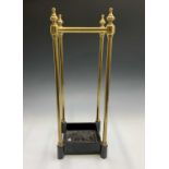 A brass four section umbrella or stick stand with turned finials and black painted base. Height
