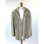 A quality pale mink jacket with silk lining in good clean condition, size 12/14.