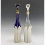 A 19th century Bohemian blue glass decanter and stopper, with gilt heightened white overlay