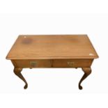 A George III style mahogany side table, with two frieze drawers on shell carved cabriole legs with