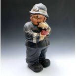 A 20th century painted papier-mache model of a policeman, indistinctly signed to base. Height 59cm.