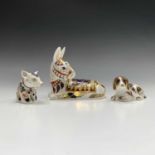 Three Royal Crown Derby paperweights - 'Thistle' the donkey, 'Scruff' the dog, and a piglet. Largest