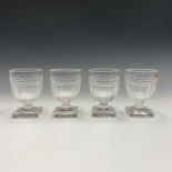 A set of four Regency glass rummers, with diamond cut and faceted bowls, on squat short stems and