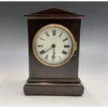 An Edwardian oak cased mantel timepiece, the plain case with angled pediment and white circular dial