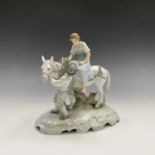 A Continental porcelain figure group, early 20th century, modelled as a lady on a horse with a boy
