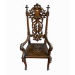 A large carved oak armchair, late 19th century, possibly Masonic, with a carved pierced splat