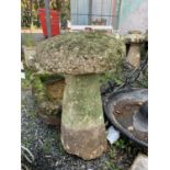 A granite staddle stone with circular top and tapered base. Height 80cm.