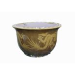 A large Chinese jardiniere decorated with dragons in relief, impressed mark to rim, diameter 67cm.