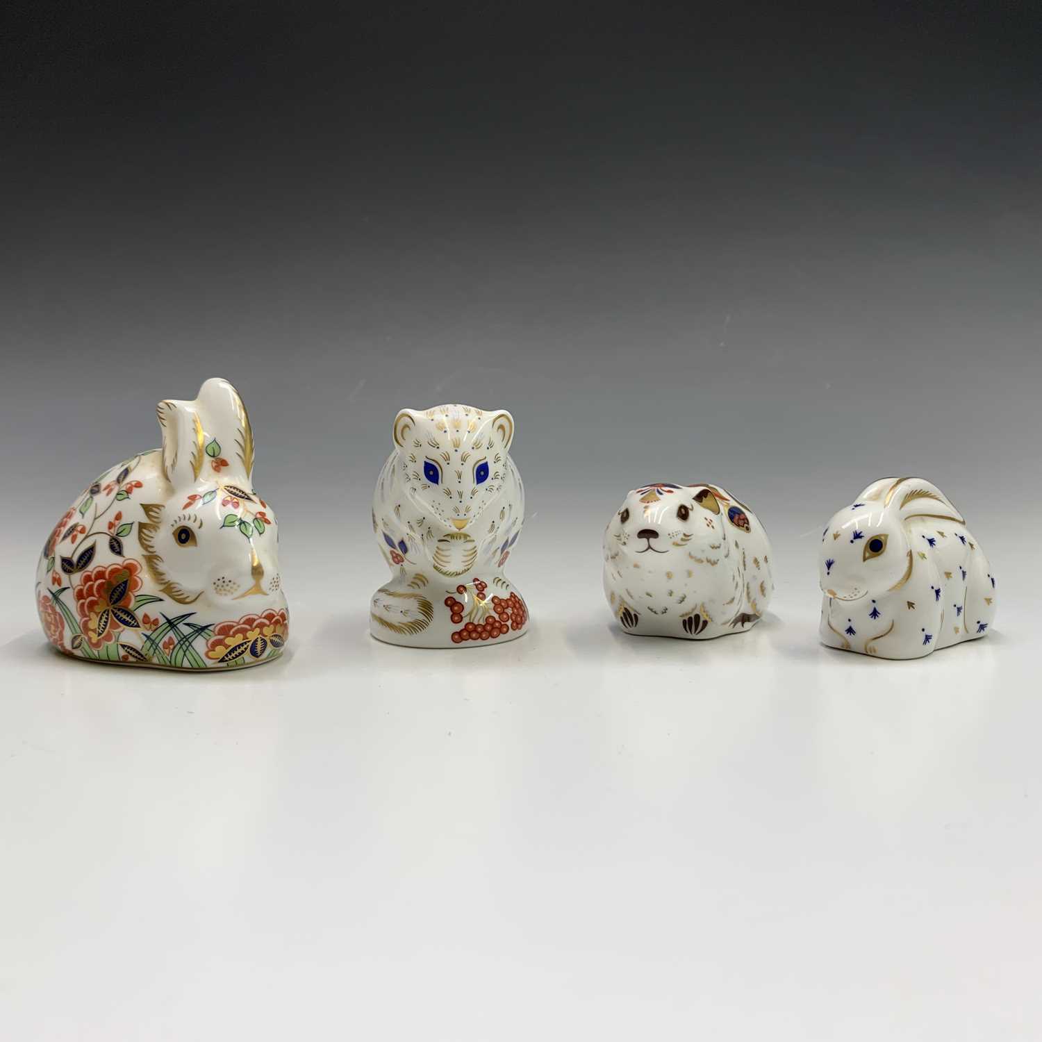 Four Royal Crown Derby paperweights - 'Meadow Rabbit', one other rabbit, 'Derby Doormouse' and 'Bank