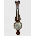 A Victorian mahogany wheel barometer, inlaid in the Neoclassical taste, the silvered dial signed P.