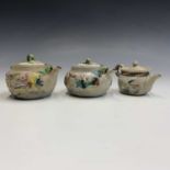 A Japanese moulded clay Yixing type teapot, with impressed motifs and applied and painted floral and