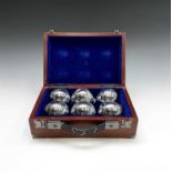 A set of chrome boules, with jack in a wooden carry case, width 28cm.
