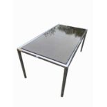 A chrome and smoked glass dining table, by Rodney Kinsman for OMK design, height 72cm, width