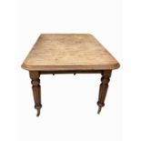 An early Victorian mahogany extending dining table, the rectangular moulded top on turned and fluted