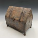 An Eastern carved hardwood casket, with iron straps and clasp, decorated roundels and chevrons,