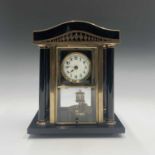 A German 400 day torsion clock, in a black enamel and brass architectural case with column supports.