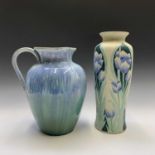 A pottery jug, height 31cm, and a Moorcroft style tube lined vase with tulip decoration (2).
