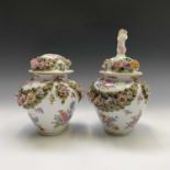 A pair of 19th century German porcelain vases and covers, of baluster form, with floral painted