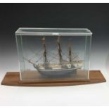 A painted wood scale model of HMS Bounty, with four cannon, unrigged, length 48cm, contained in a