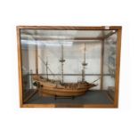 A model of the ship 'Golden Hind', built by Ray Deacon, 1980, contained in a glazed oak case with