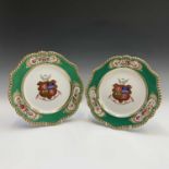 A pair of Chamberlains Worcester porcelain armorial plates, with painted and gilt crests