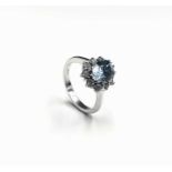 A cluster ring with an aquamarine of 1.34cts within diamonds set in 18ct white gold