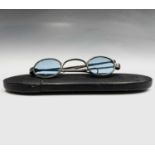 A pair of 19th-century silver spectacles with blue-tinted lenses, papier-mache case