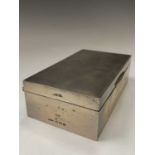 An engine-turned silver cigarette box