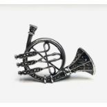 A silver and marcasite French Horn brooch