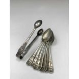 A set of eight silver teaspoons and matching tongs 4.6oz