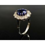 An impressive sapphire and diamond oval cluster platinum ring. The sapphire weight is calculated