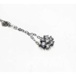 A diamond flowerhead cluster pendant on an 18ct white gold chain, 1.5g